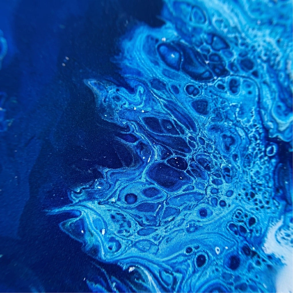 Close-up of blue and black textured surface with bubbles