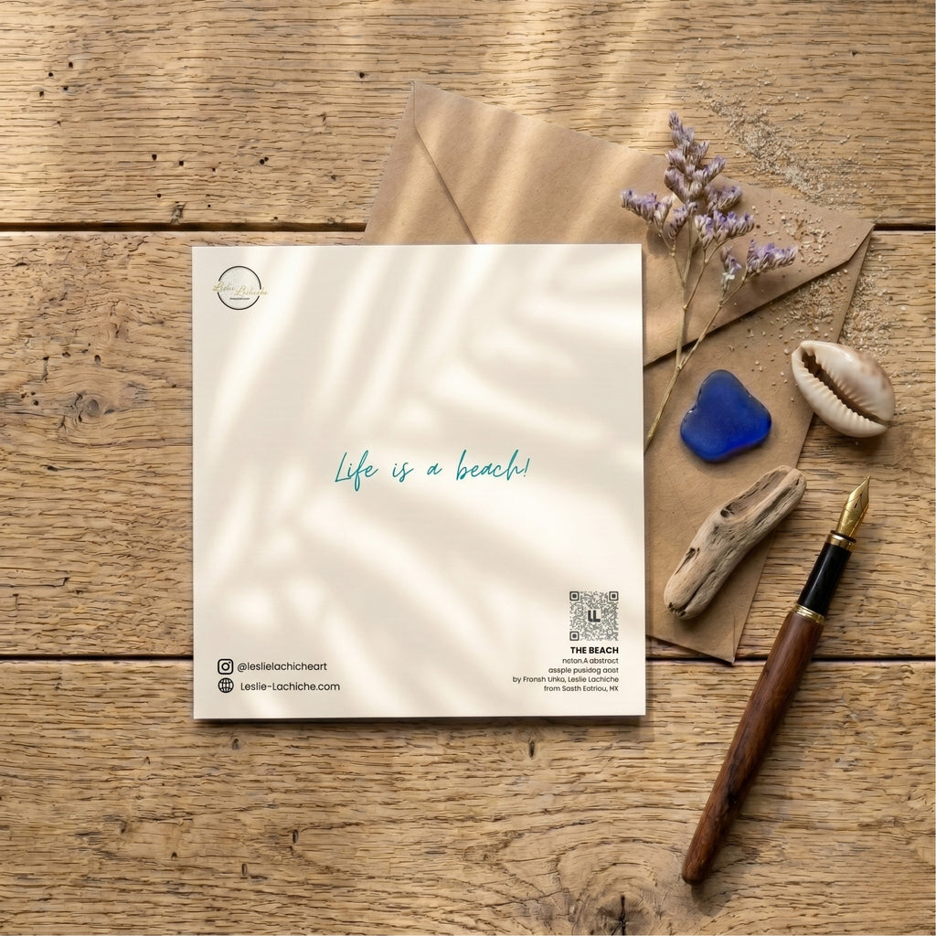back  card with 'Life is a beach' text on a wooden surface with an envelope, flowers, and a pen.