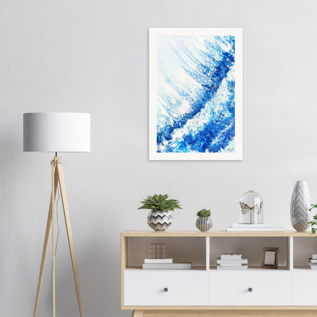 Framed abstract blue artwork on a wall above a wooden sideboard with decor items.