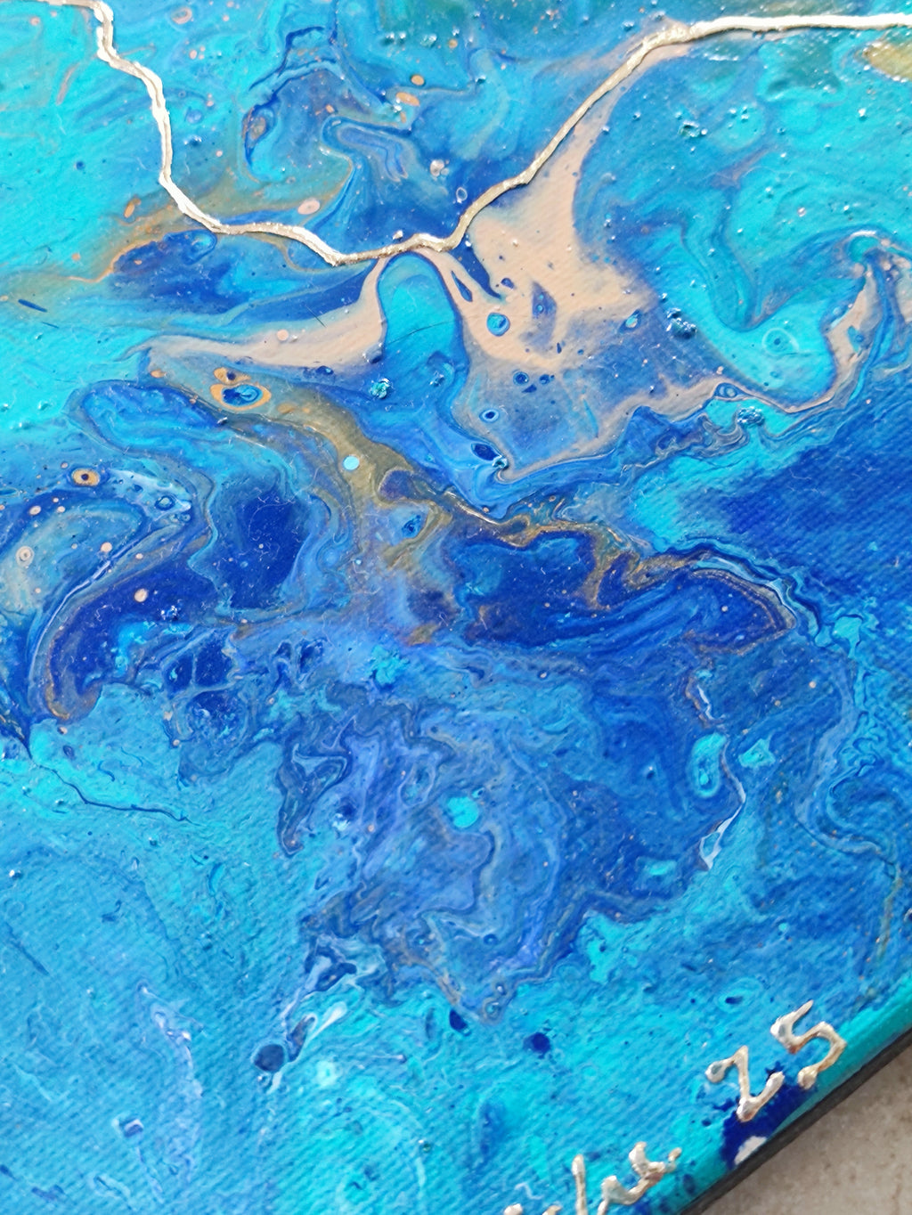 Blue and gold abstract art with swirling patterns