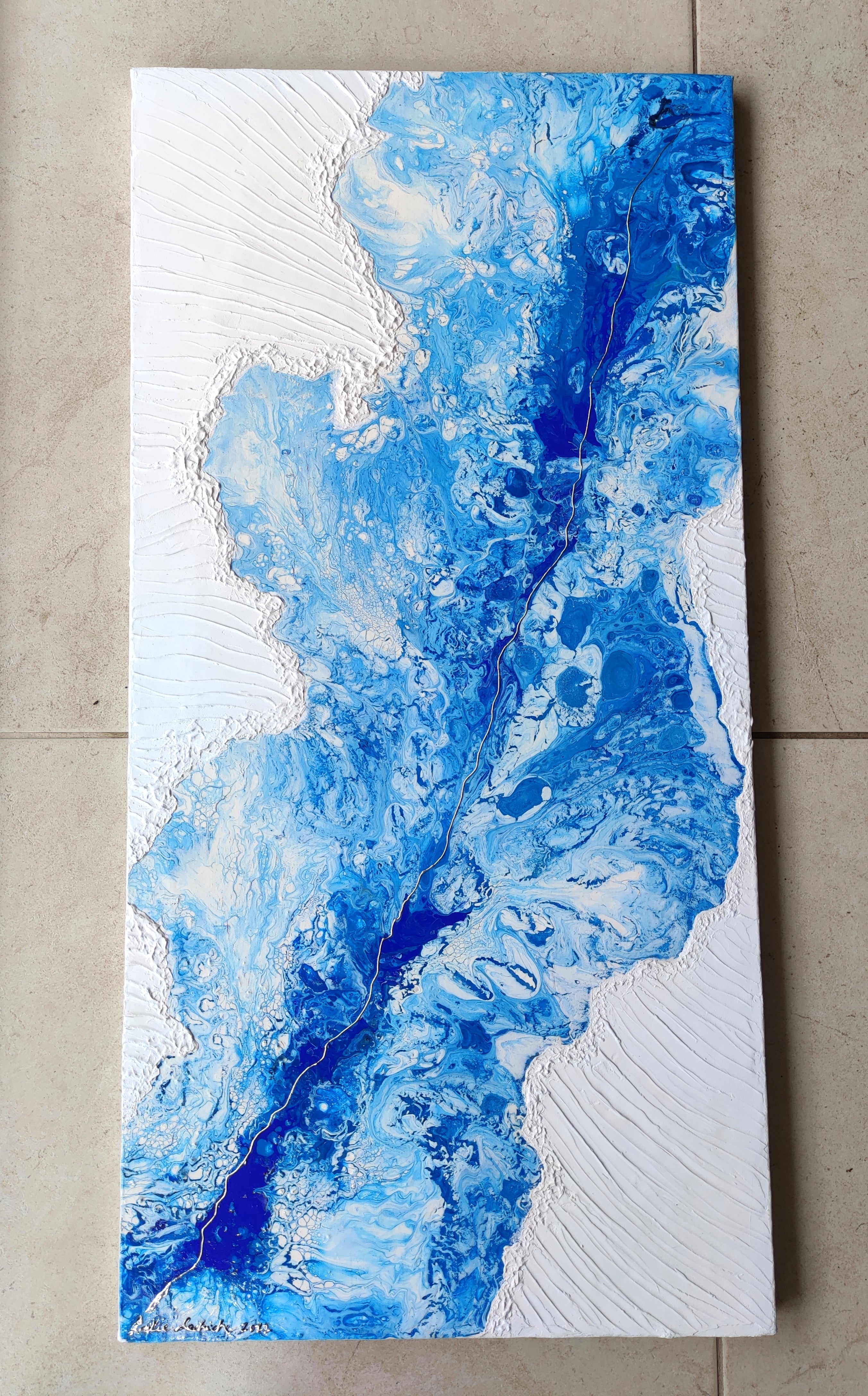 Abstract blue and white painting on a textured surface