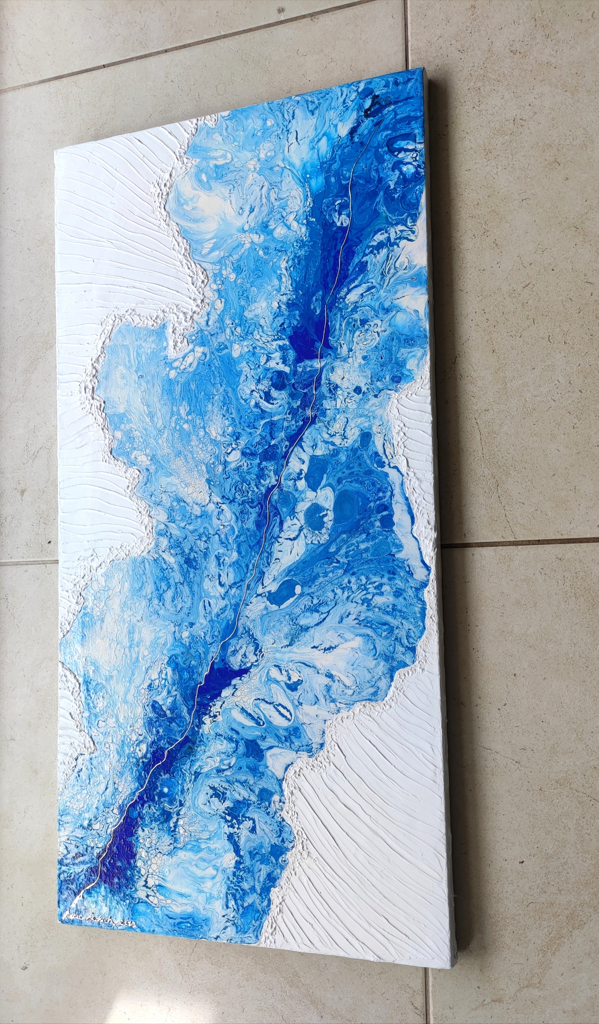 Abstract blue and white painting on a textured wall