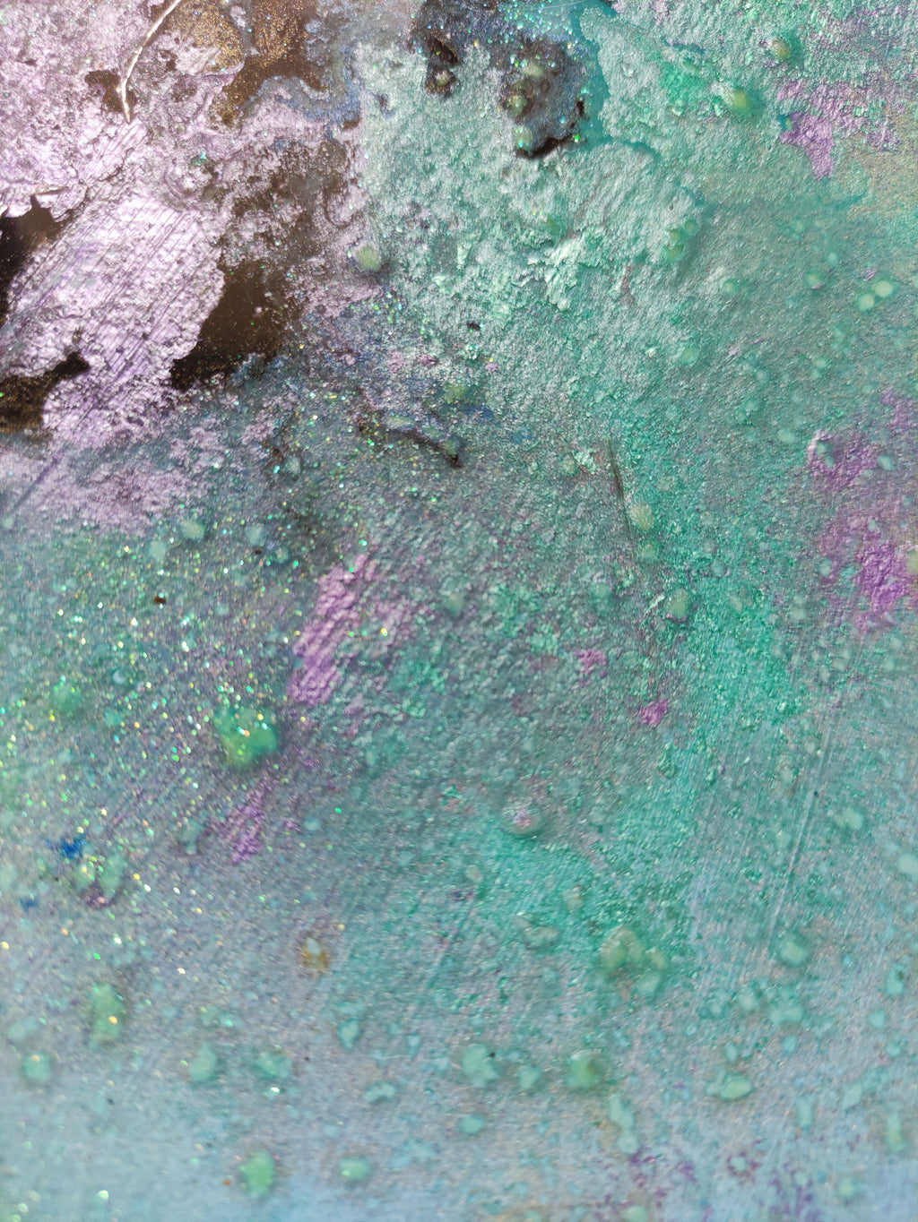 Close-up of a textured surface with green, purple, and brown colors