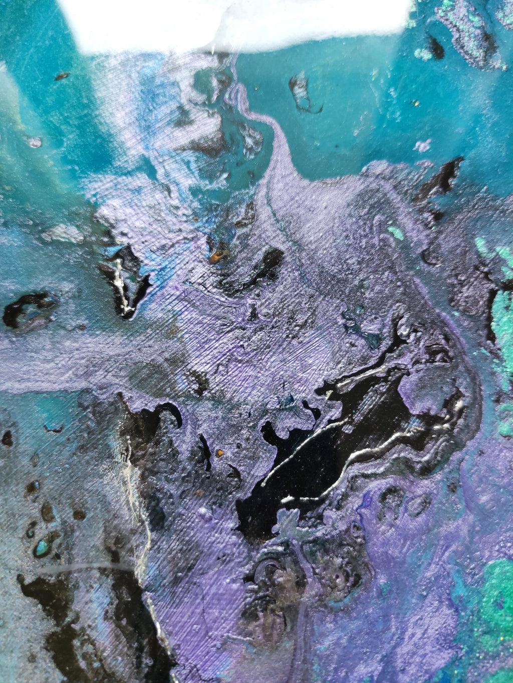 Close-up of a textured surface with green, purple, and brown colors