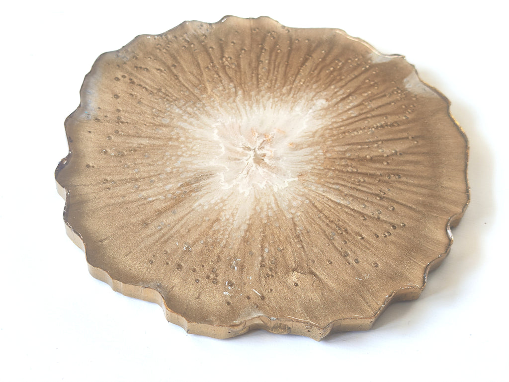 Round ceramic plate with textured coaster  on a white background