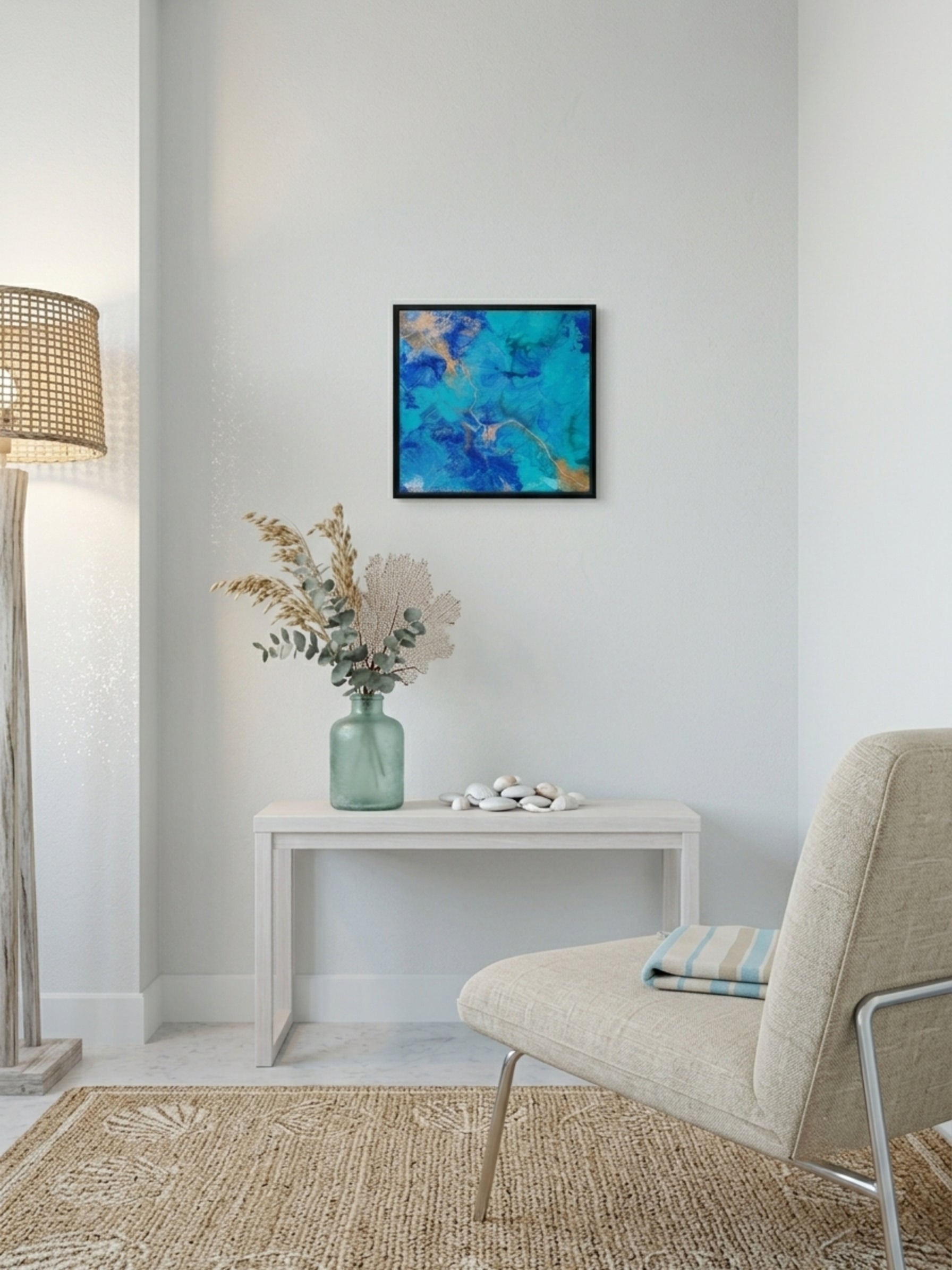 Modern interior with a chair, table, lamp, and abstract painting on a white wall.