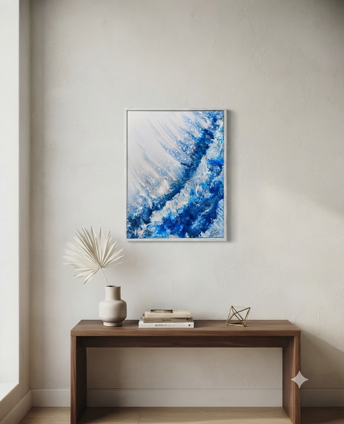 Abstract blue painting on a wall above a wooden console table with decorative items.