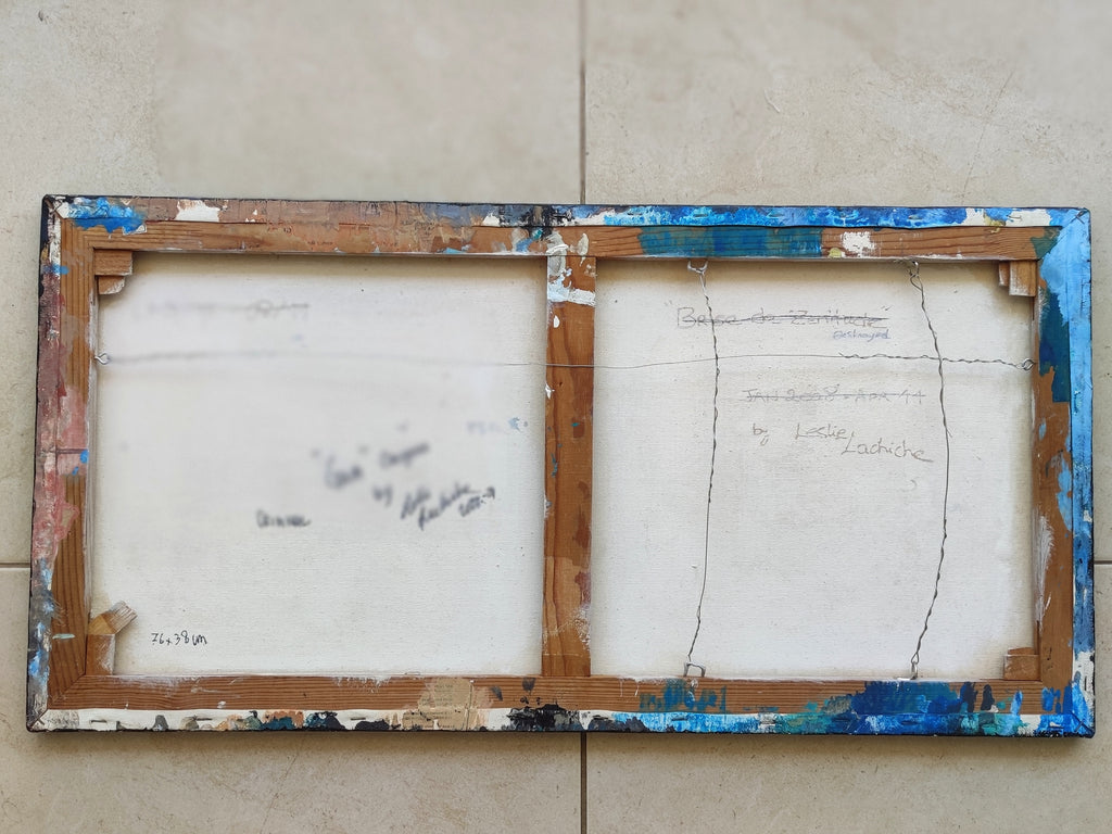 Two wooden picture frames with white canvas on a tiled wall background