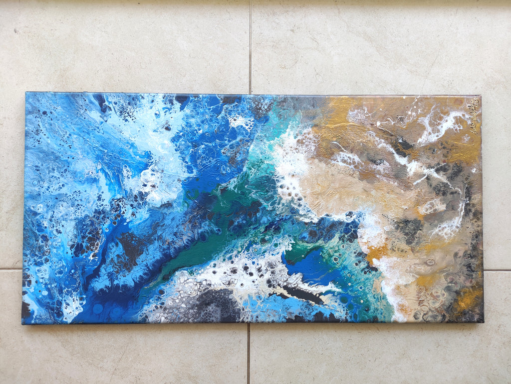 Abstract painting with blue, gold, and white on a beige wall