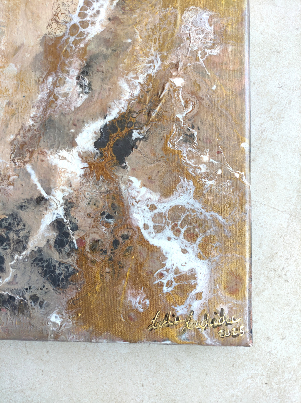 Abstract art piece with gold, brown, and white colors on a textured background