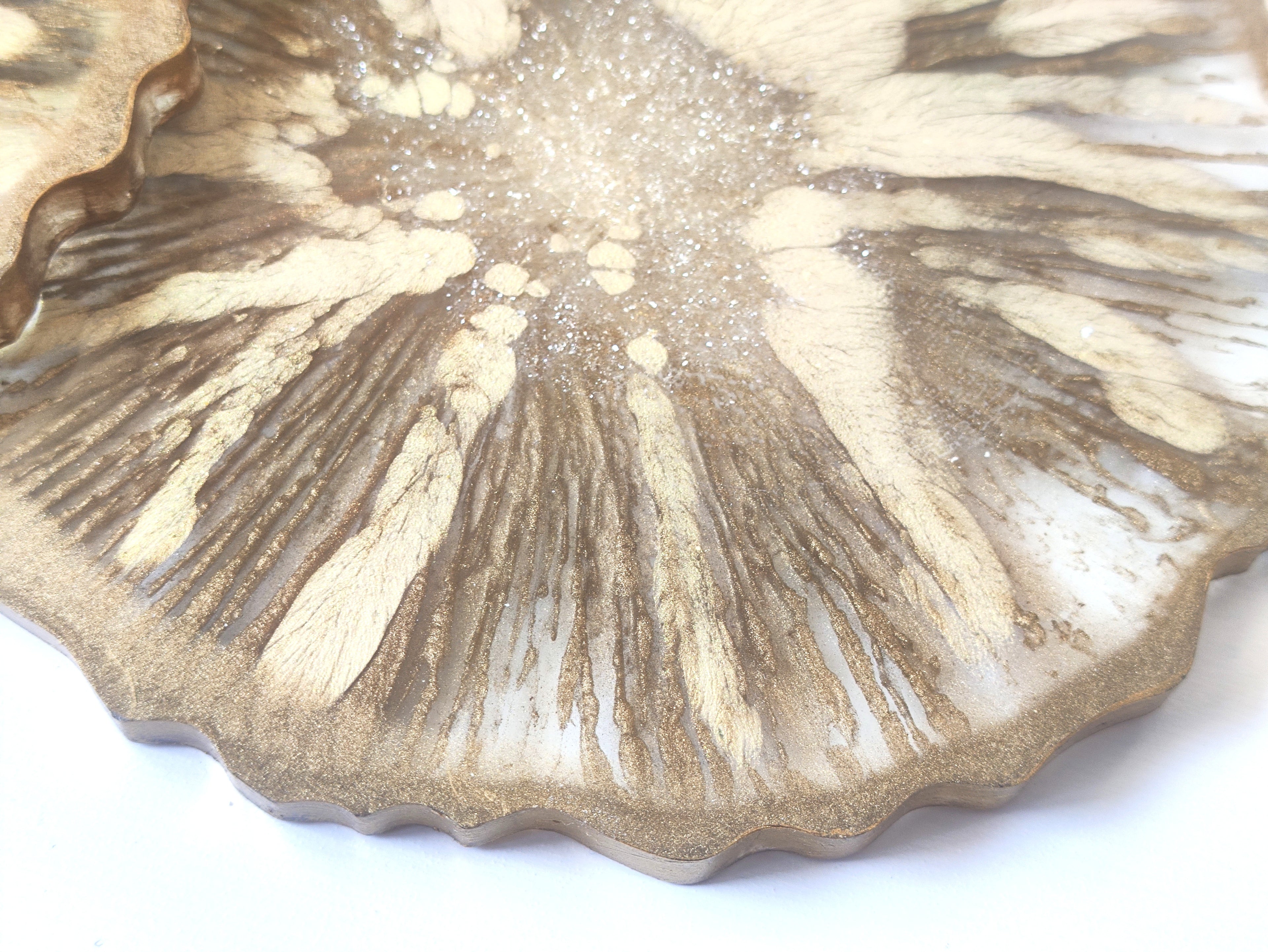 Close-up of a textured ceramic plate with a scalloped edge on a white background