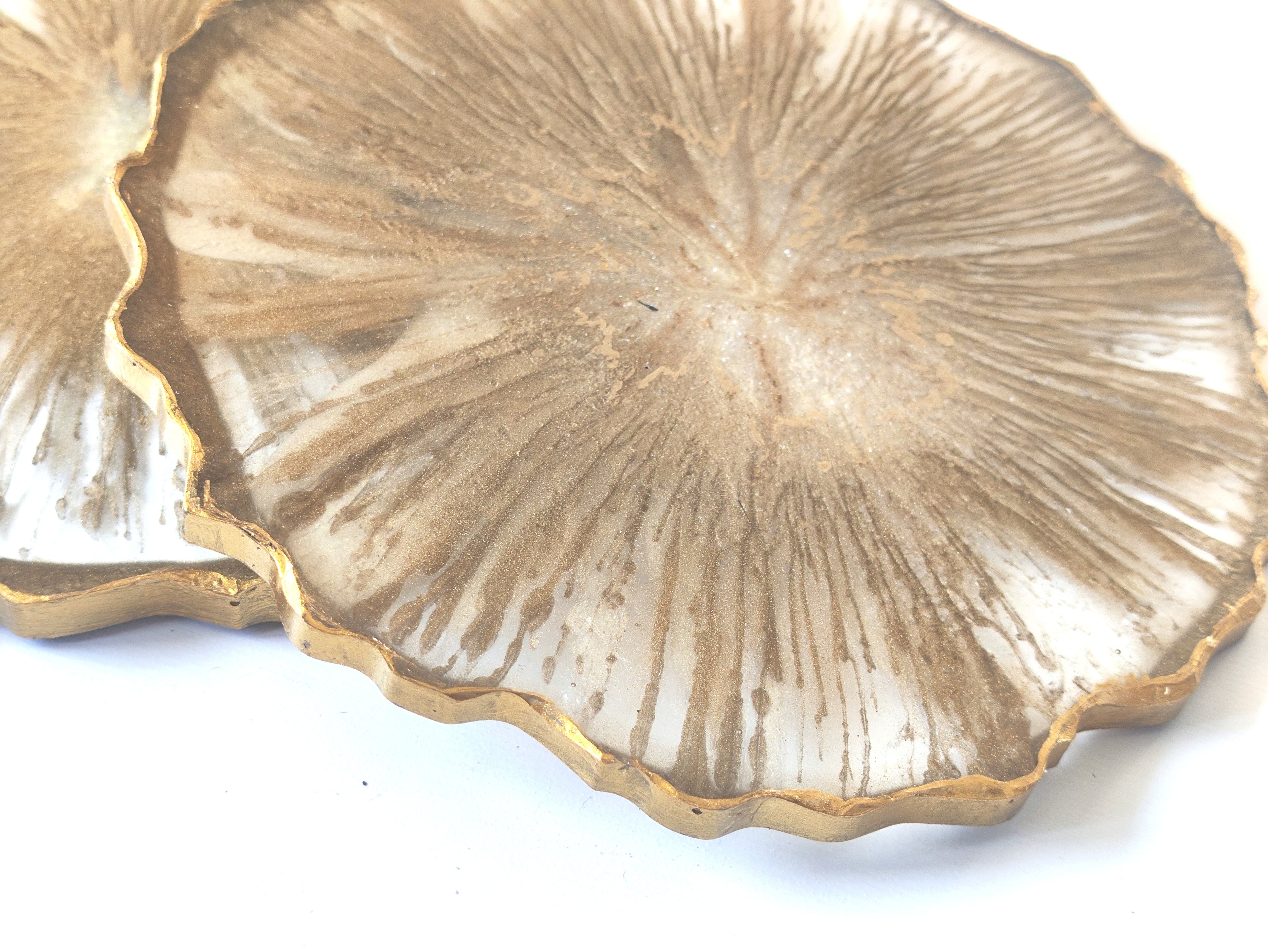 Decorative plate with gold rim and textured surface on a white background