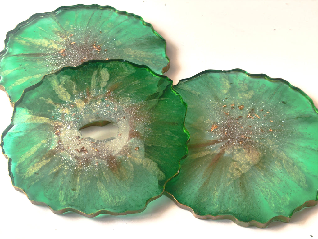 Three green ceramic plates with textured surface on a white background