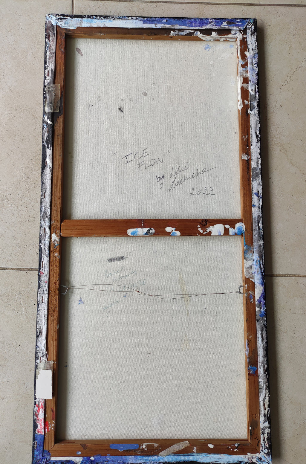 Vintage wooden window frame with 'Ice Flow' text on a beige wall