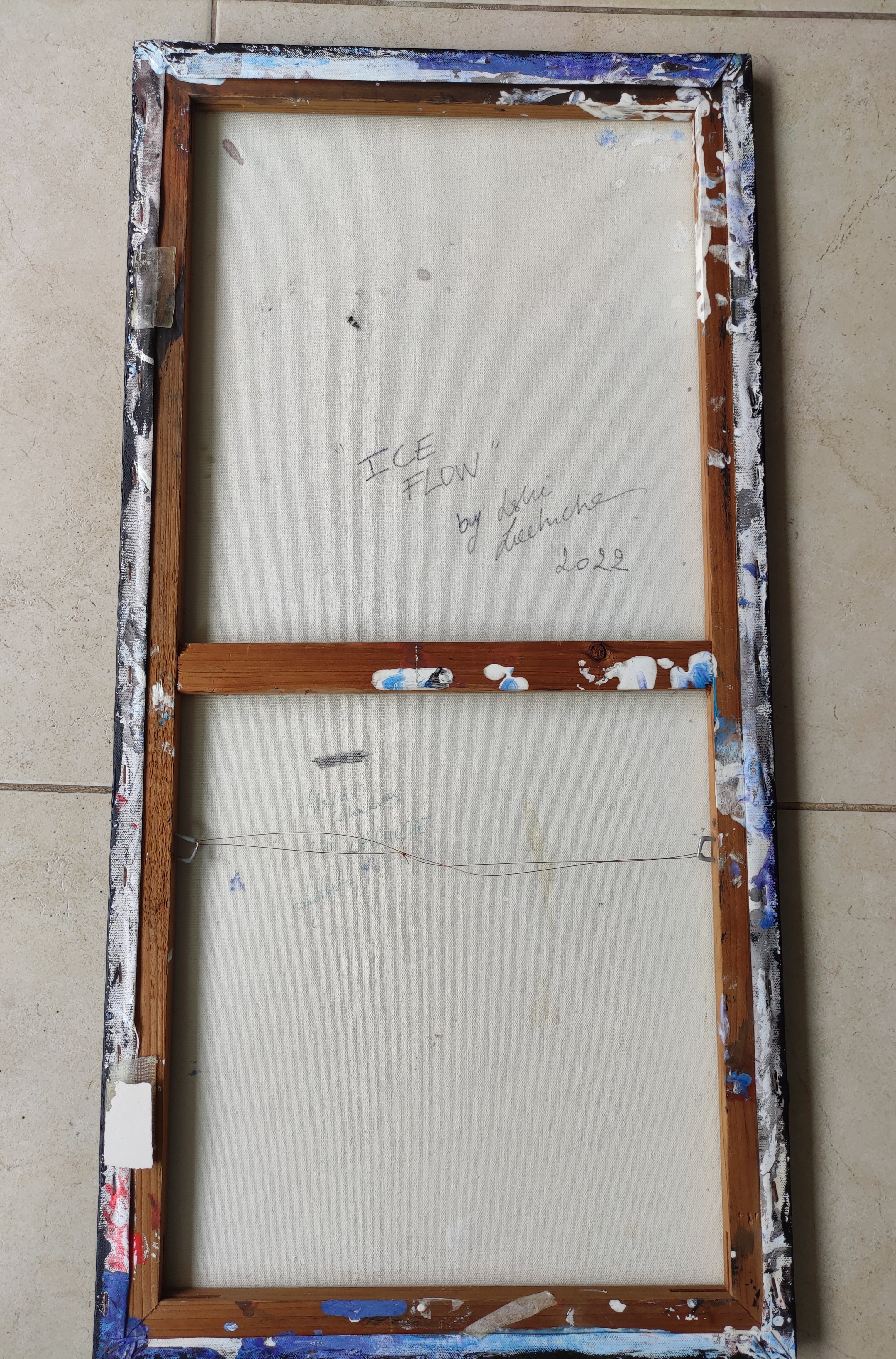 Vintage wooden window frame with 'Ice Flow' text on a beige wall