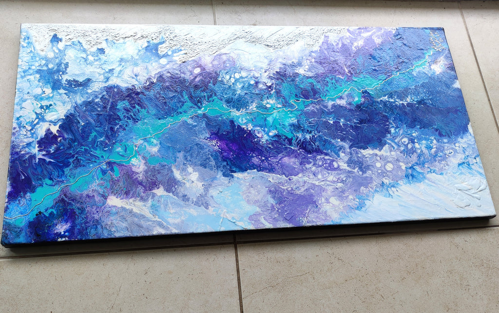 Abstract blue and purple painting on a textured surface