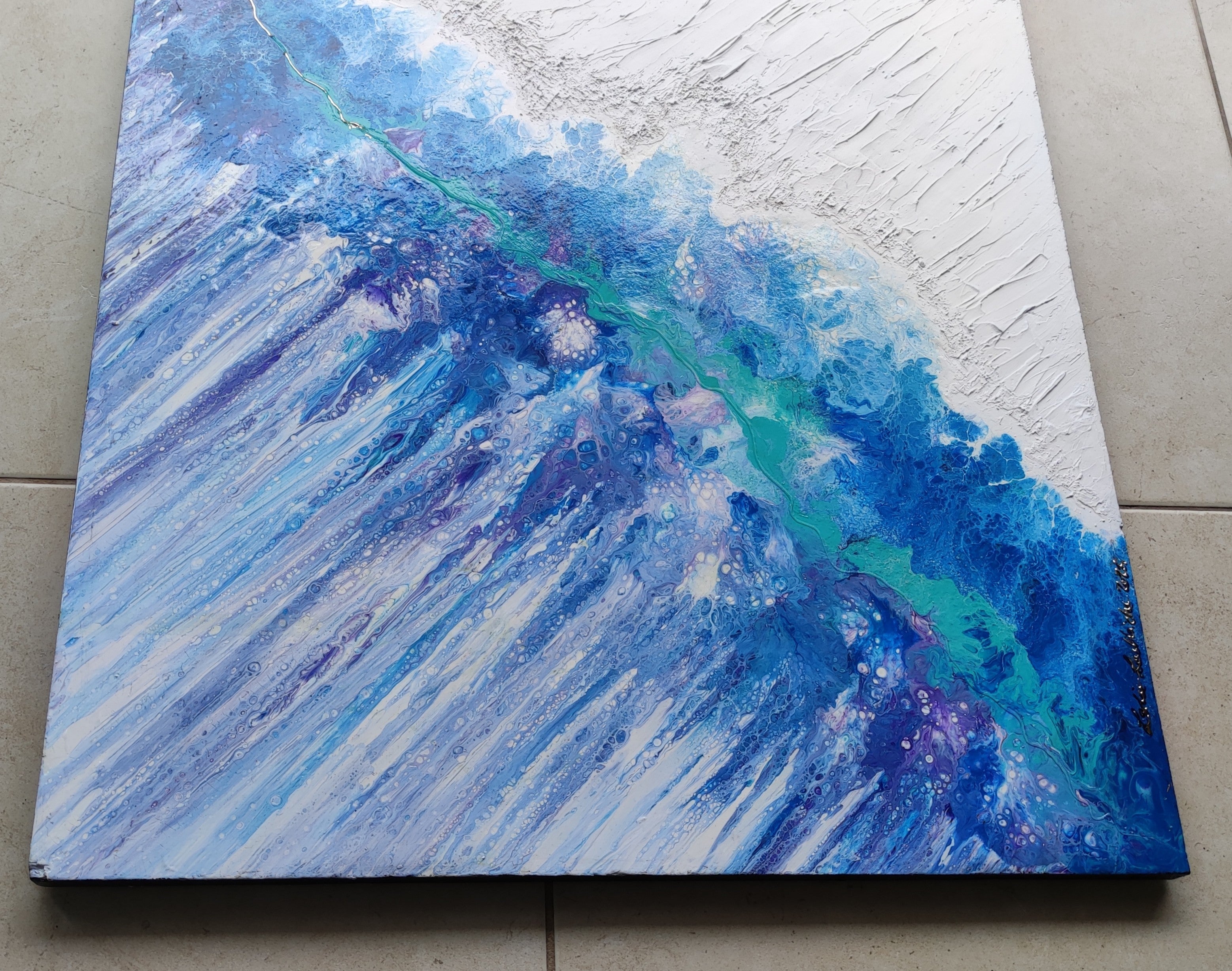 Abstract painting with blue and white strokes on a textured surface
