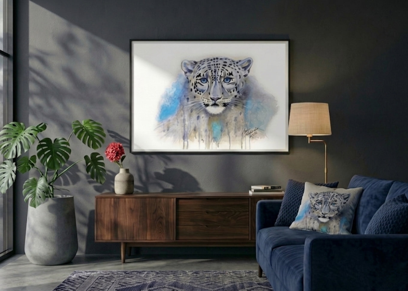 Living room with a blue sofa, wooden cabinet, and framed artwork of a snow leopard.