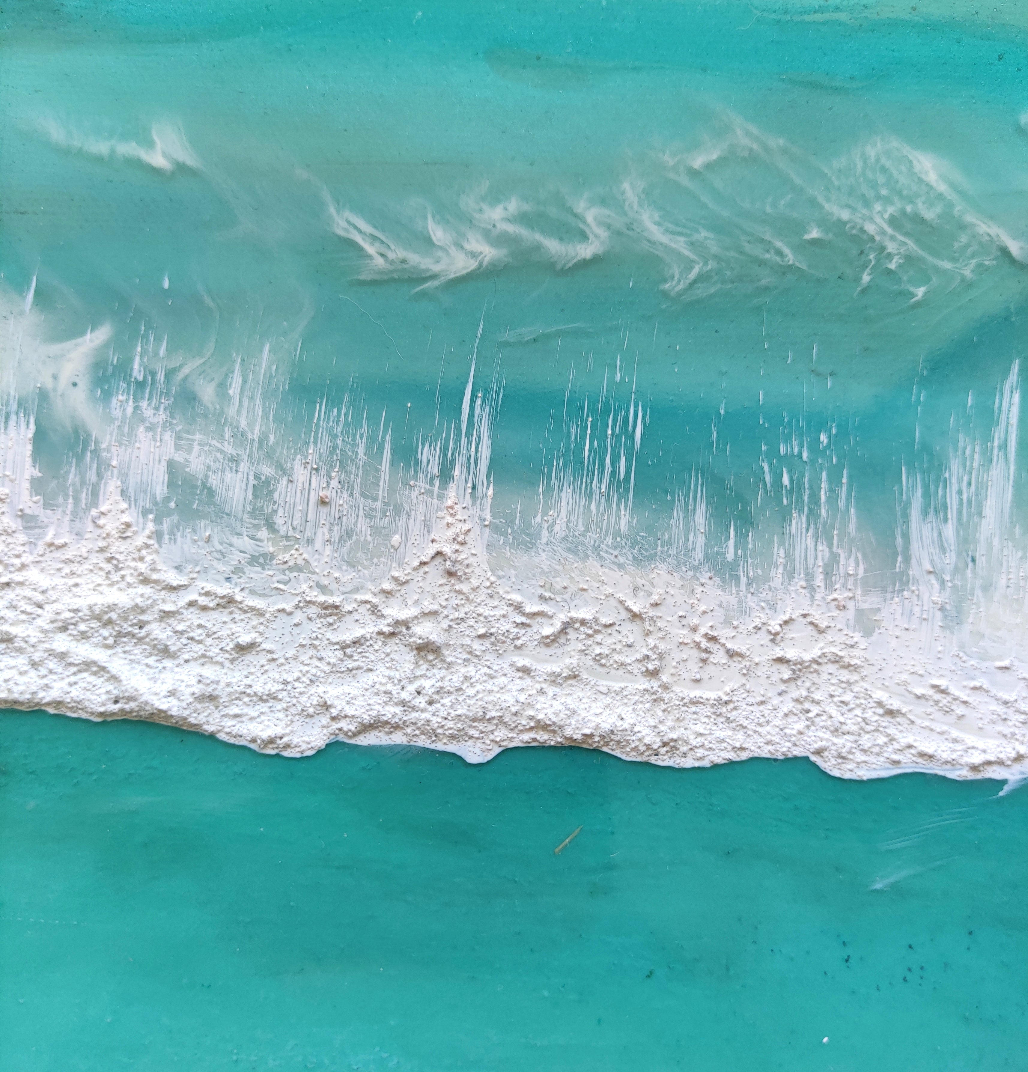 Artistic depiction of a beach scene with turquoise water and sand, featuring a brand name.