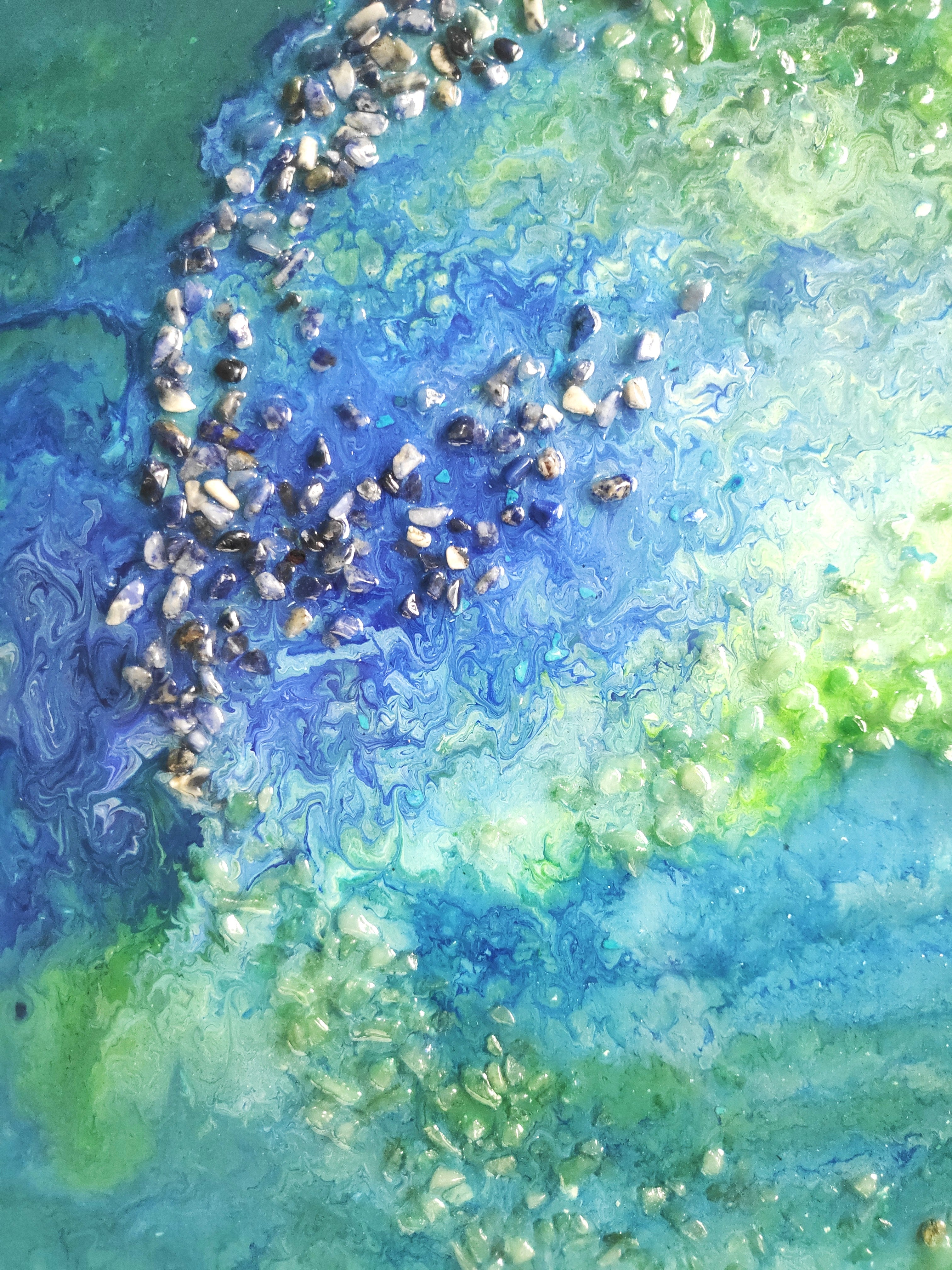 Abstract art with swirling blue, green, and white colors