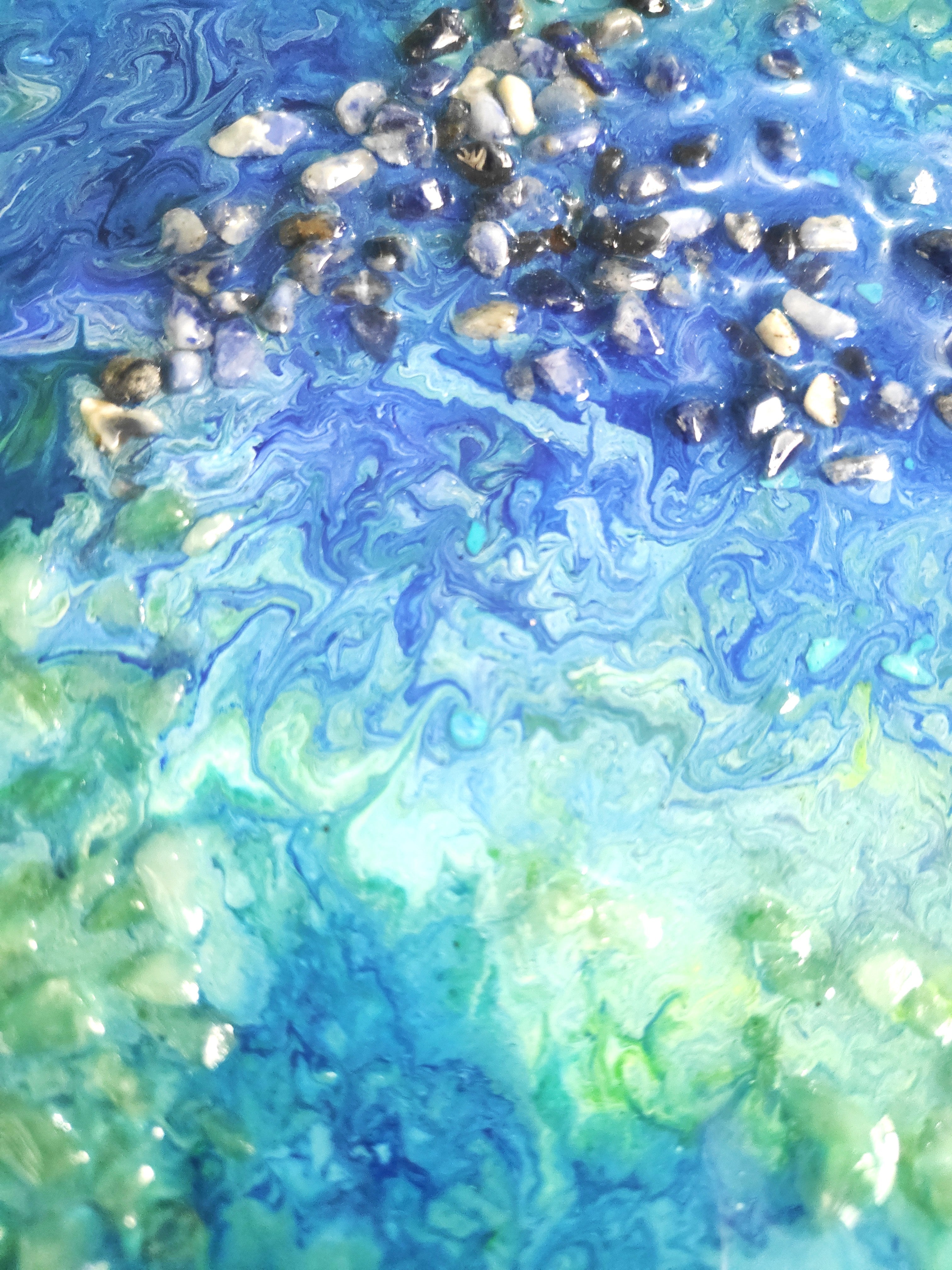 Marbled blue and green surface with small pebbles crystals
