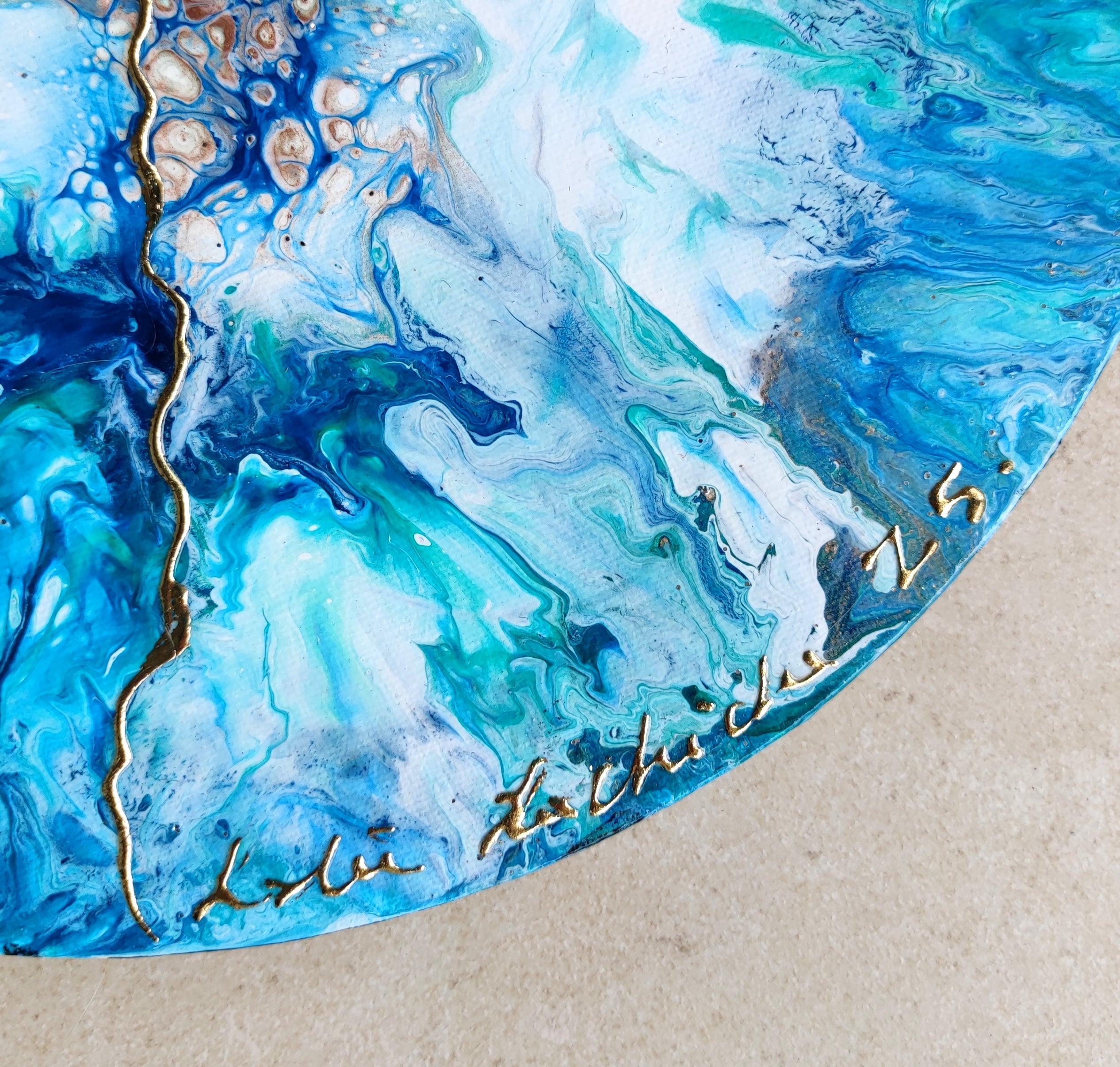 Abstract blue and green painting with gold accents on a beige background