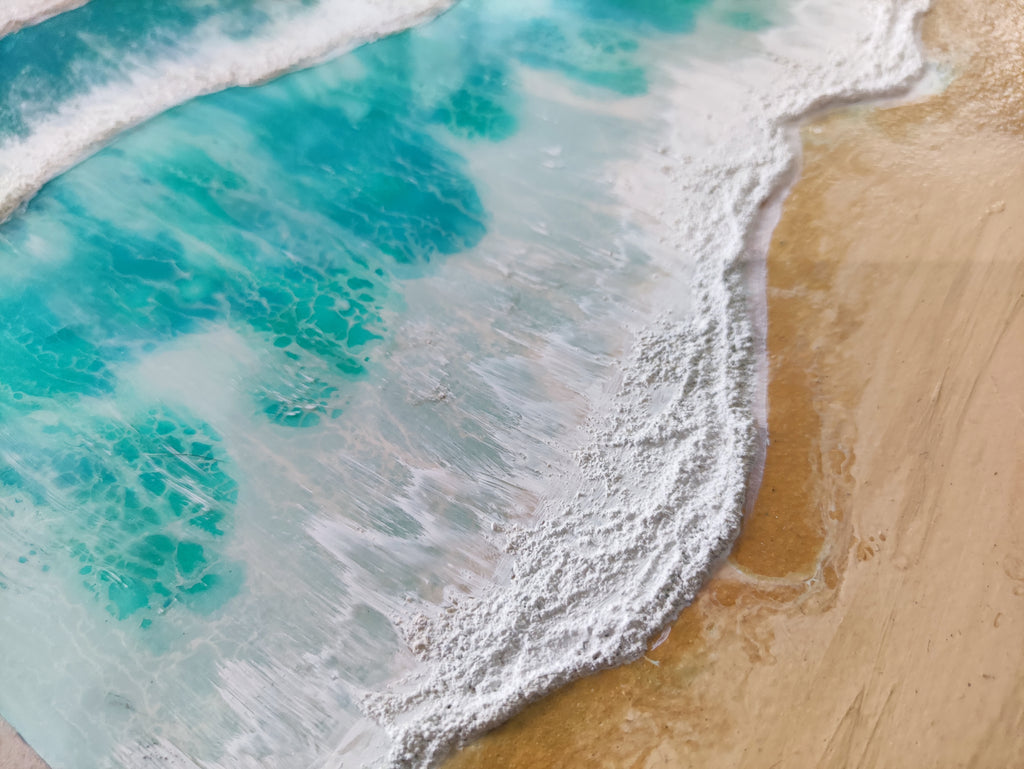 Close-up of ocean waves crashing onto a sandy beach
