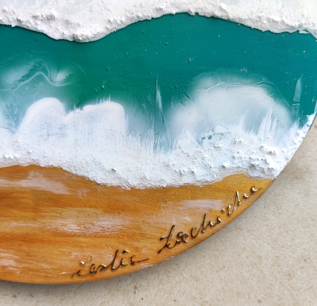 Wooden coaster with ocean wave design and 'Lacie' branding on a concrete surface.