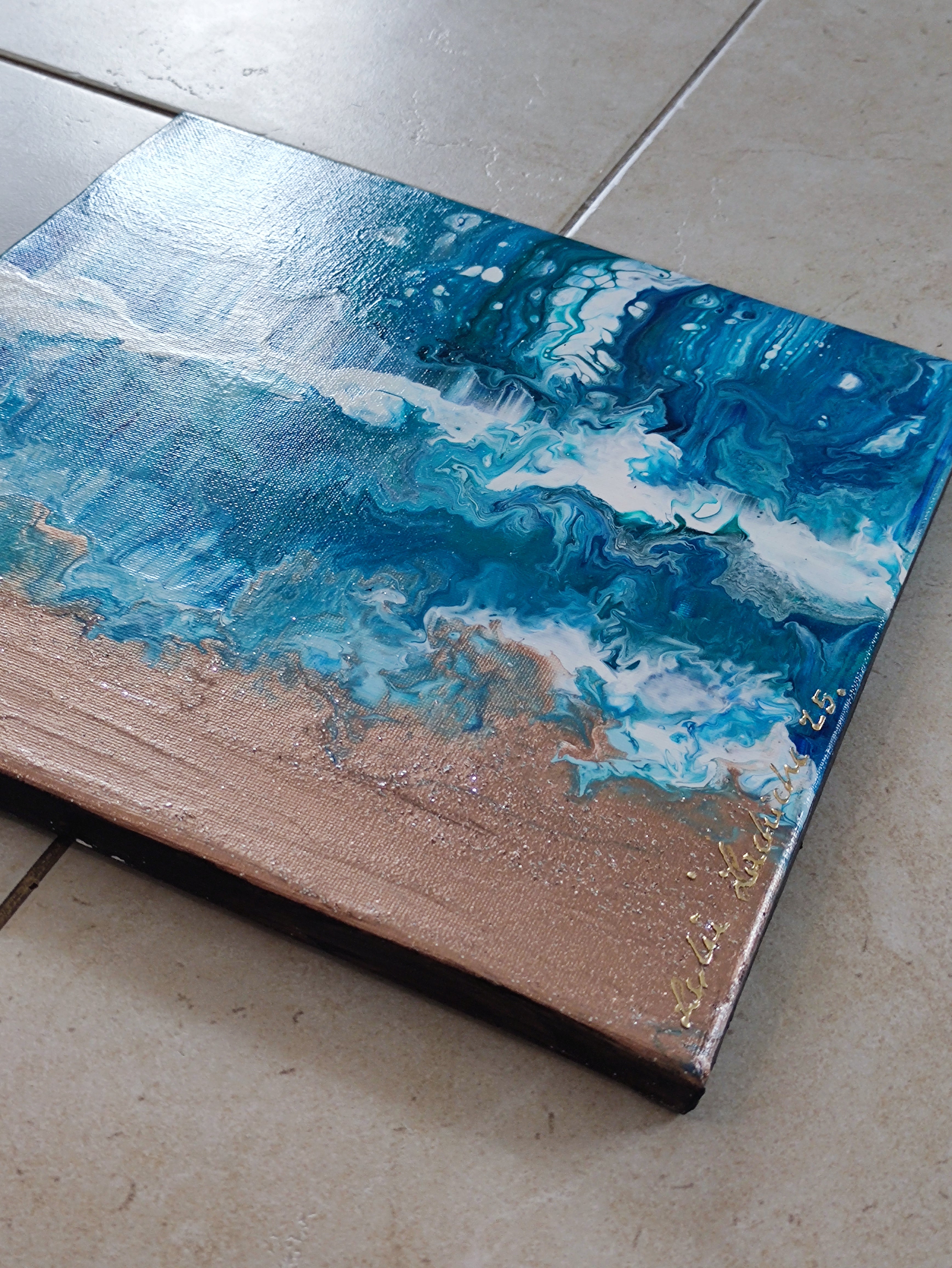 Abstract art piece with blue and white patterns on a brown surface