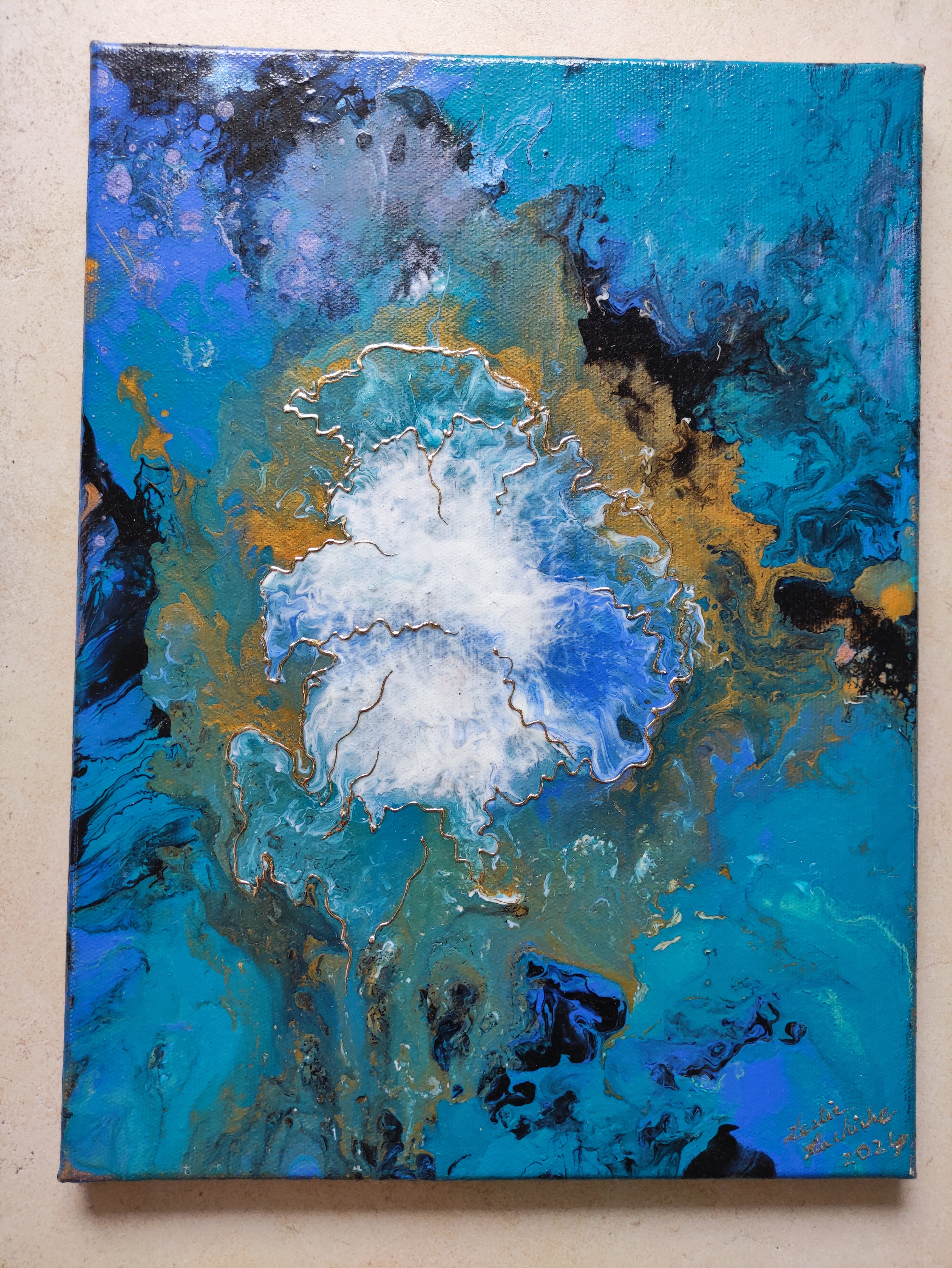 Abstract painting with blue, white, and gold colors on a beige background
