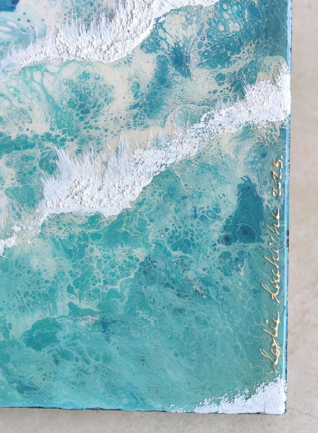 Marbled artwork with teal and beige tones, signed 'Leticia Maldonado' on the right.