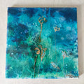 Abstract artwork with gold floral elements on a blue and green background