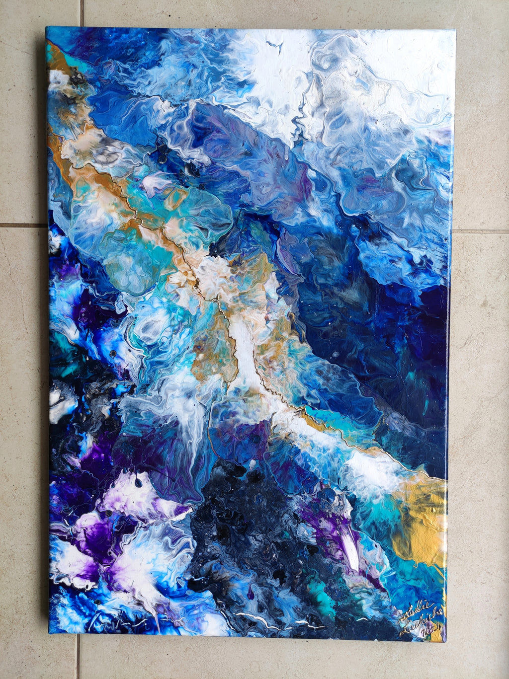 Abstract art painting with blue, purple, and gold colors on a beige tile background