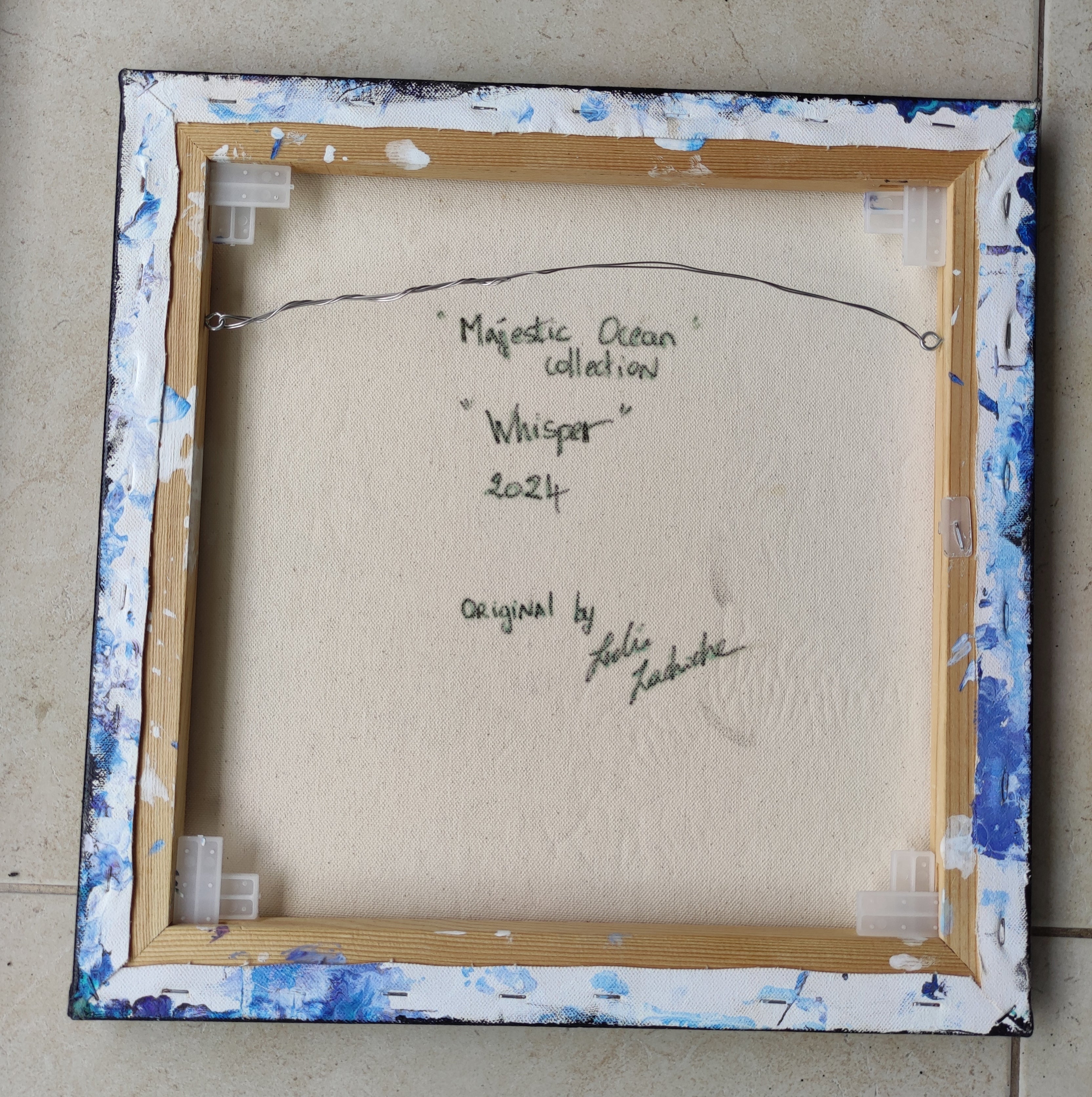 Back of a framed artwork with text and signature