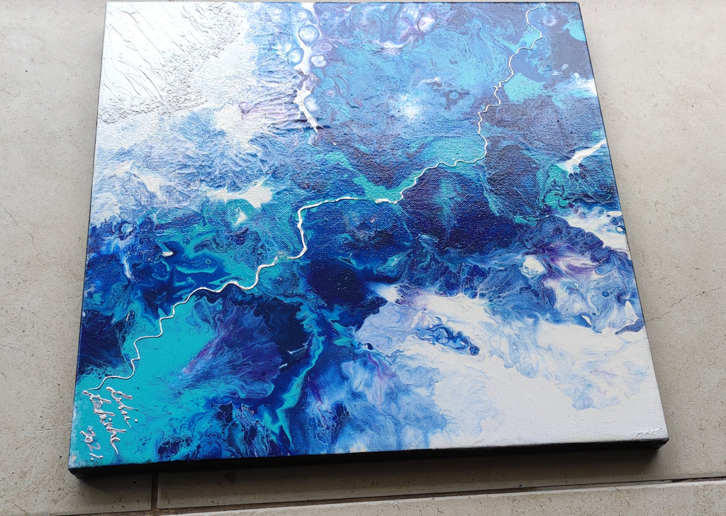 Abstract blue and white painting on a textured surface