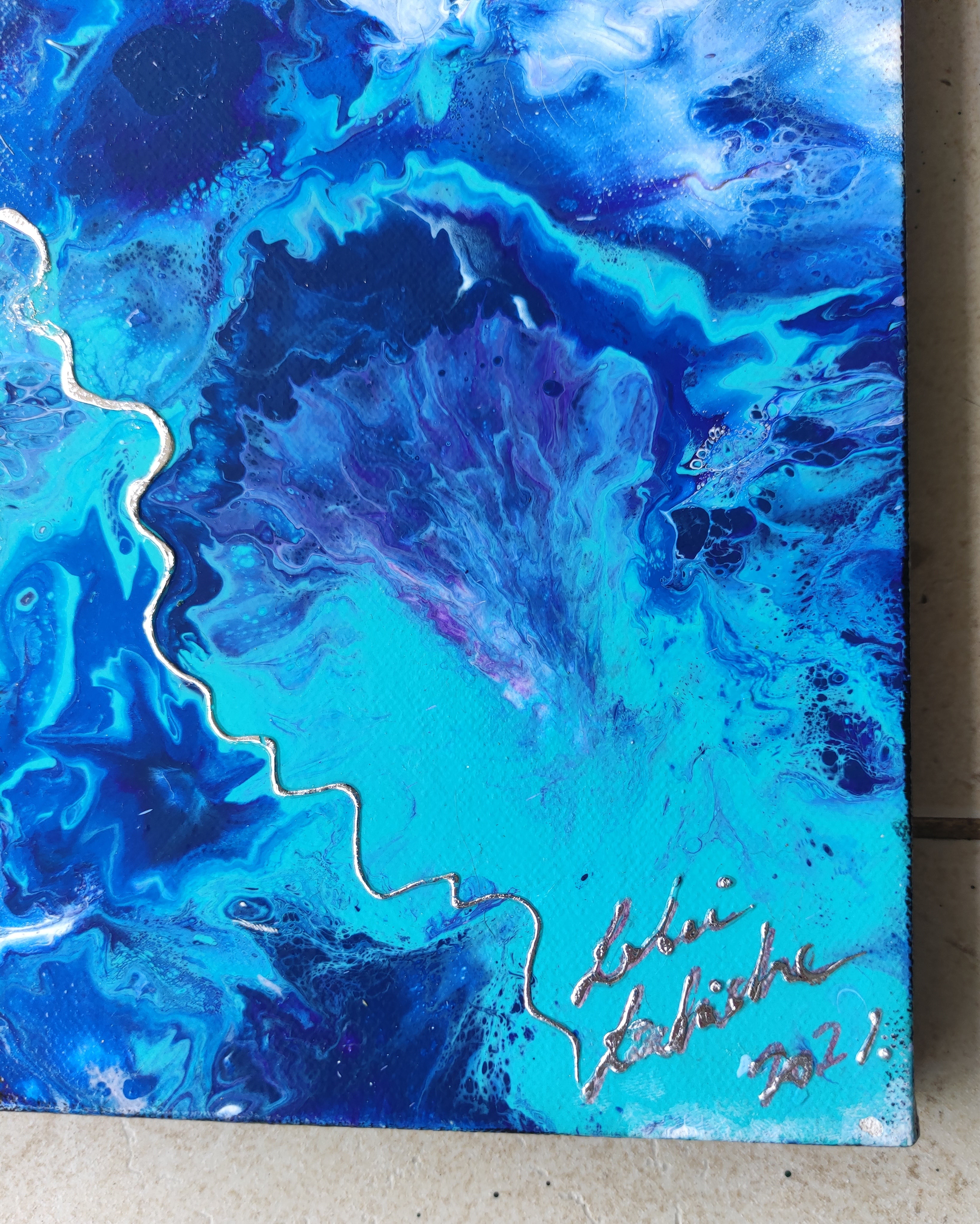 Blue and purple abstract painting with a signature on a textured surface