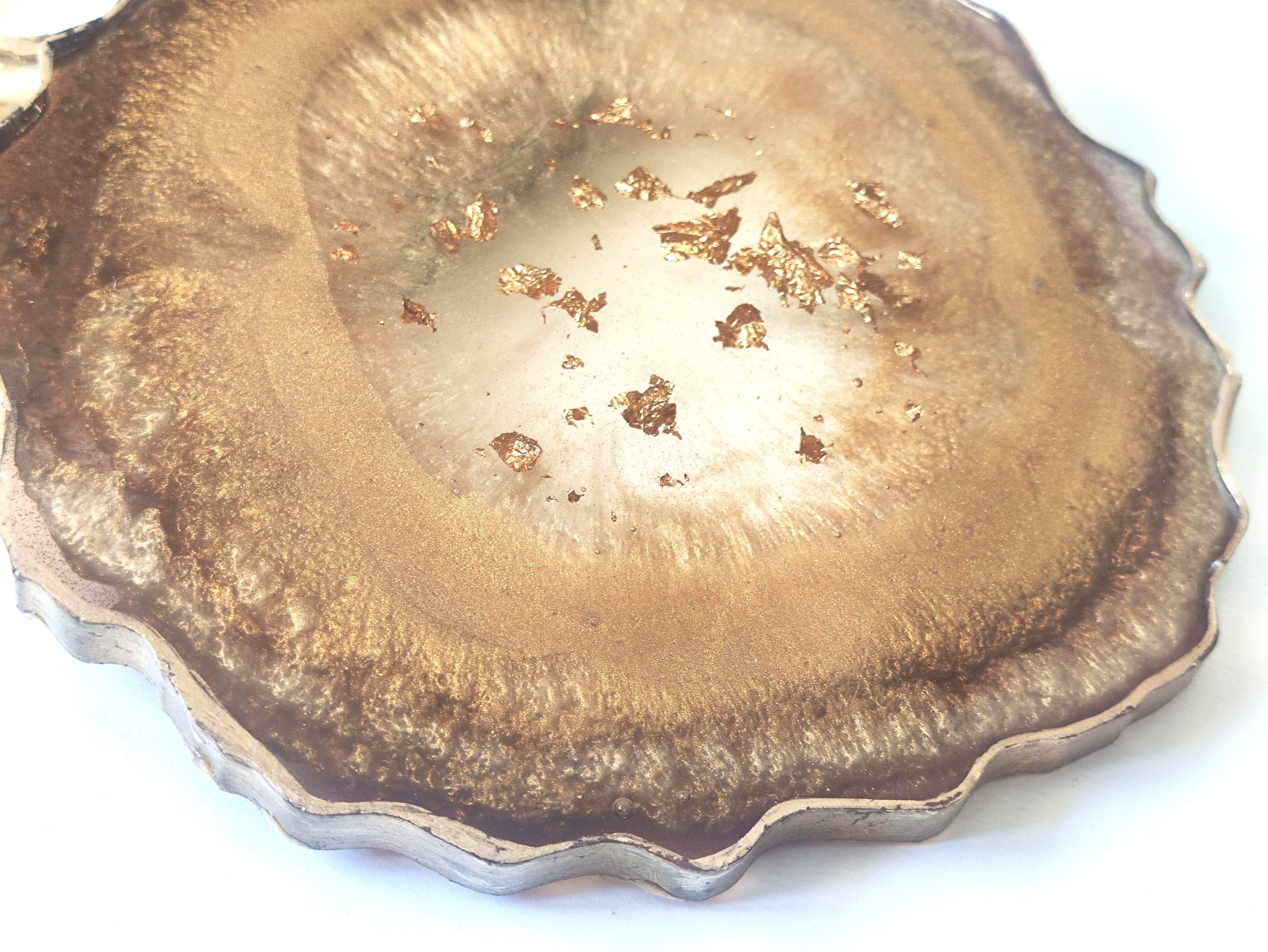 Close-up of geode coaster with gold specks on a white background