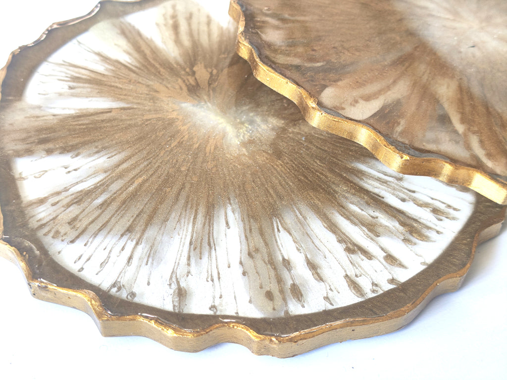 Decorative plate with gold rim and textured center on a white background